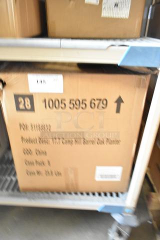 Cardboard box labeled "Camp Hill Barrel Oak Planter," showing scratches and dents. Contains a brand new set of pastry boxes.