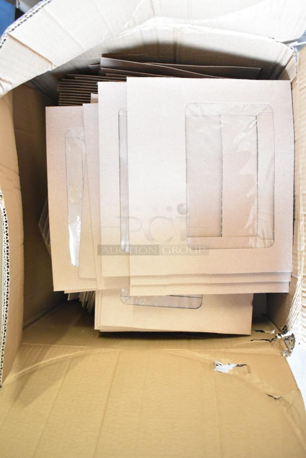 Box of new pastry boxes, visible scratch and dent on cardboard. Each box has a clear window. Ideal for bakery display.