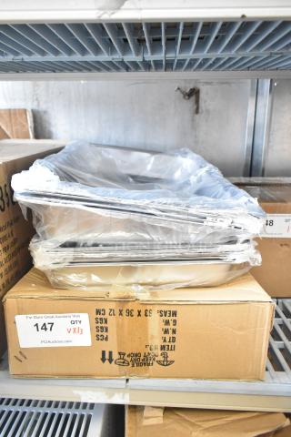 13 new scratch and dent items, including stainless steel drop-in bins and folding metal chafing dish frames, boxed.