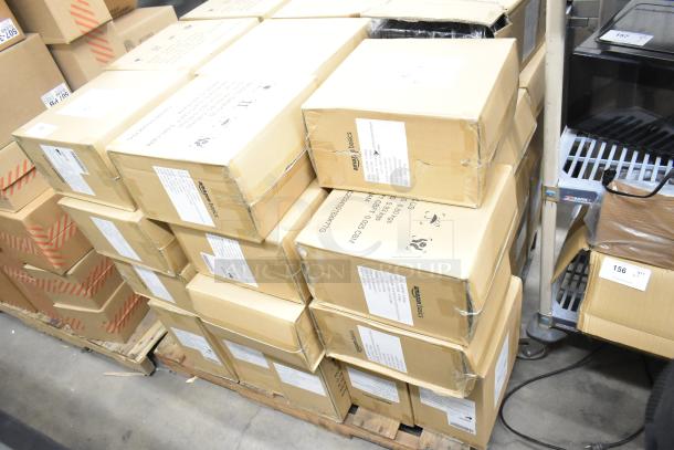 Stack of boxes containing Amazon Basics 12-sheet cross-cut paper shredders, brand new with some boxes showing scratches and dents.