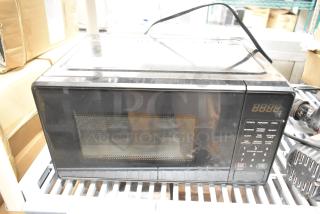 Countertop microwave oven, model MSF0B100072352, with keypad controls and digital display. Includes plate. 120 Volts, 1 Phase.