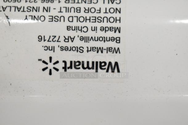 Countertop Microwave Oven Model MSF0B100072352, 120V, shows Walmart tag, made in China. Includes plate.