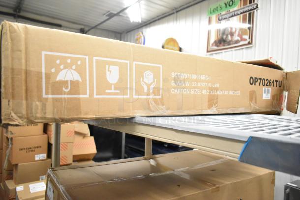 Brand new OP70261TU Costway patio rattan lounge chair in original box, 49.21x23.03x7.87 inches, with handling labels.