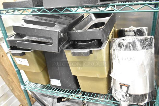 Two-tier lot with beverage holder dispensers and rice cooker inserts on a metal shelf. Items are labeled and mostly wrapped.