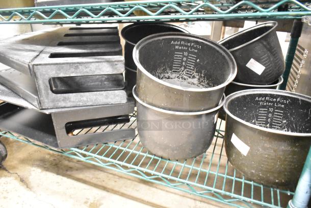 Two-tier lot with beverage holder dispensers and rice cooker inserts on a metal shelf. Markings show capacity measurements.
