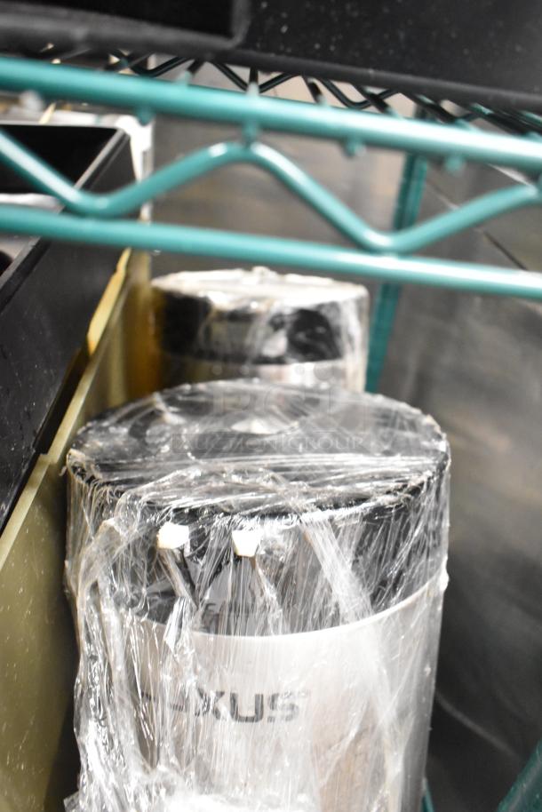 Two-tier lot with beverage holder dispensers, rice cooker inserts, wrapped in plastic for protection, stored on a shelf.