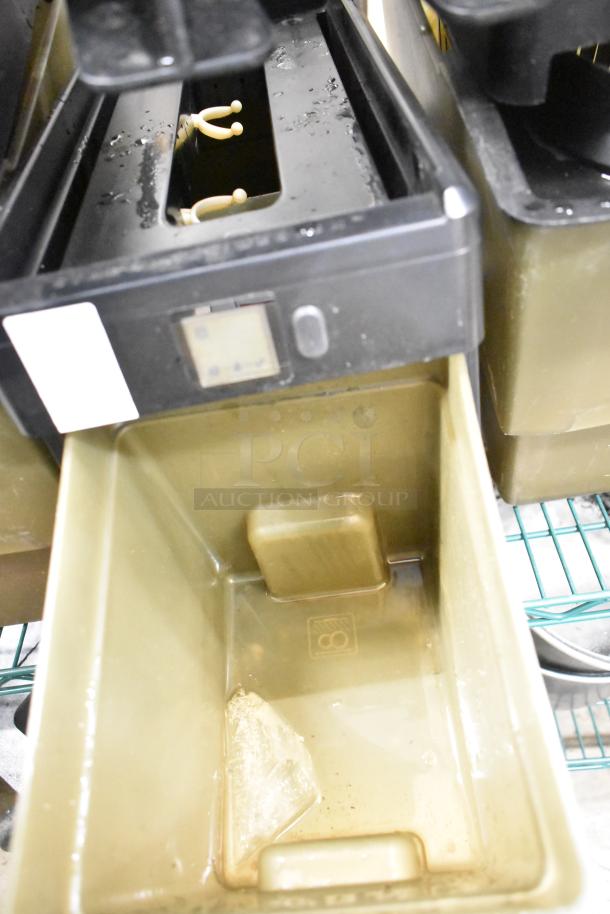 Two-tier lot of beverage holder dispensers and rice cooker inserts. Visible wear and stains; includes removable trays.