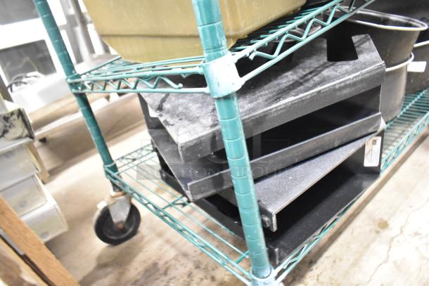 Two-tier metal shelf with various items: beverage holder dispensers, rice cooker inserts, and storage containers. Used condition.