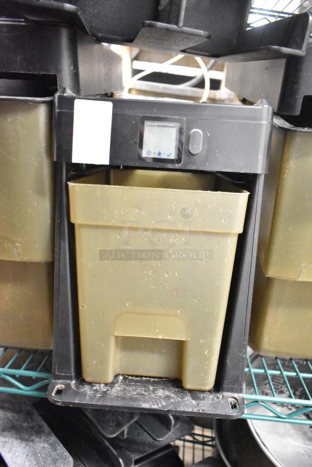 Two-tier lot with beverage holder dispenser and rice cooker insert, showing a digital display and light wear signs.