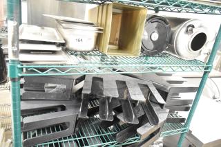 Two-tier lot with stainless steel drop-in bins, lid organizers, and kitchen items on shelving. Tag indicates auction lot 164.