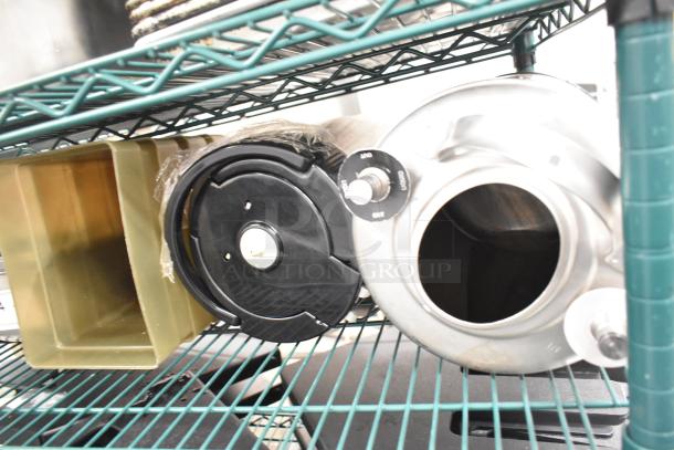 Two-tier lot with stainless steel drop-in bins, lid organizers, good condition, visible black dial with "liquid" label.