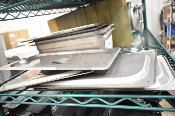 Two-tier shelf with stainless steel drop-in bins and lid organizers, varying sizes, gently used, organized for auction.