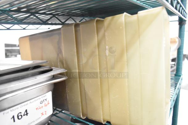 Two-tier lot with stainless steel drop-in bins and lid organizers on metal shelving. Labels indicate auction details.