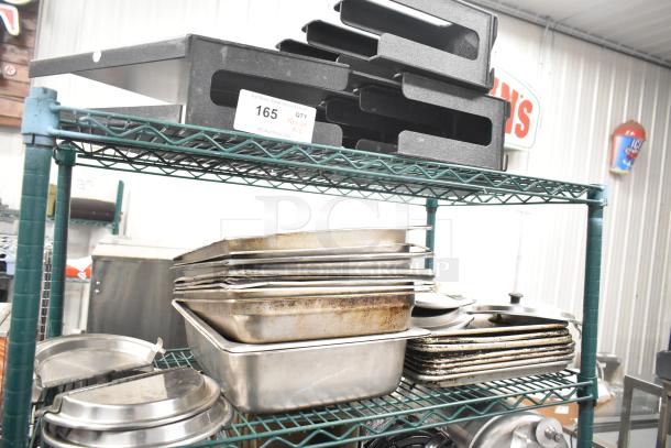 Two-tier lot with stainless steel drop-in bins, metal pans, and lid organizers on a metal rack. Auction tag reads "165".
