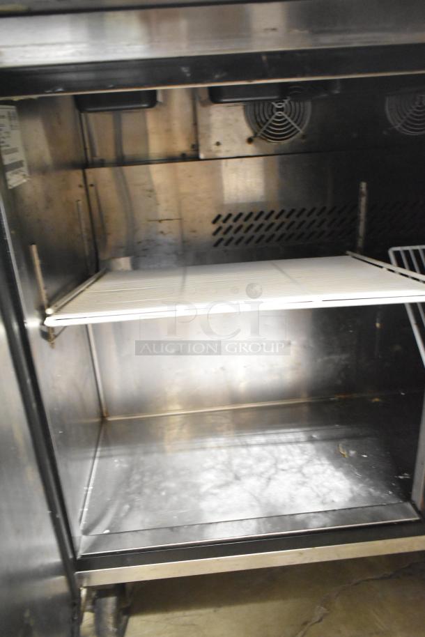 Atosa MSF8302 stainless steel prep table interior, showing shelving, ventilation, and commercial casters, 115V, 1 Phase.