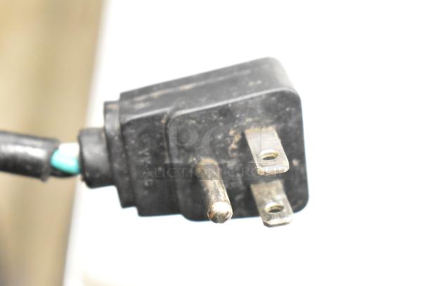 Close-up of a plug from the Atosa MSF8302 prep table, showing three prongs and a black plastic casing.