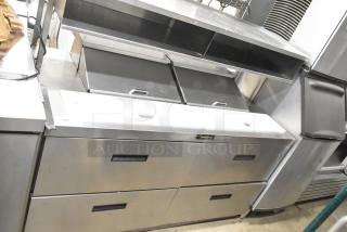 Delfield UCD4464N-12-DD5 stainless steel prep table with bain-marie mega top, over shelf, 4 drawers, on commercial casters.