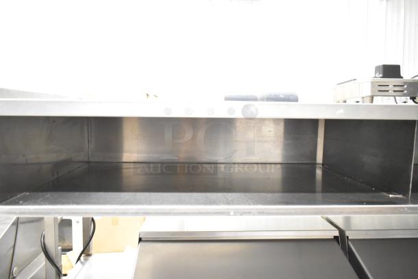 Delfield UCD4464N-12-DD5 stainless steel prep table with over shelf, 4 drawers, and casters; commercial use, great condition.