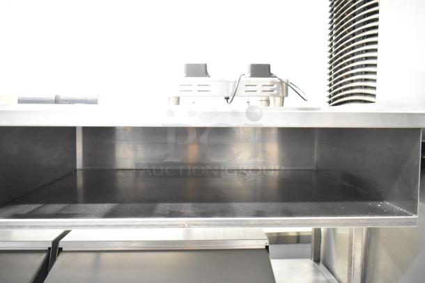 Delfield UCD4464N-12-DD5 stainless steel commercial sandwich salad prep table with over shelf, 4 drawers, and commercial casters.