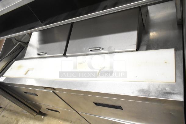 Delfield UCD4464N-12-DD5 stainless steel prep table with mega top, 4 drawers, overshelf, and casters; in good condition.