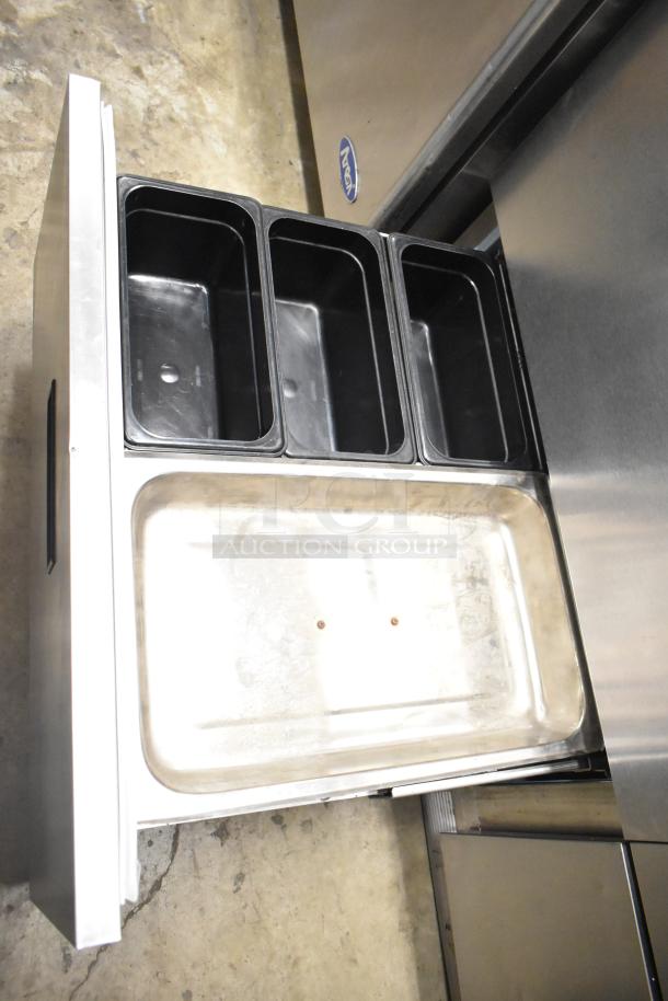 Delfield UCD4464N-12-DD5 stainless steel prep table with bain marie top, over shelf, 4 drawers, and commercial casters.