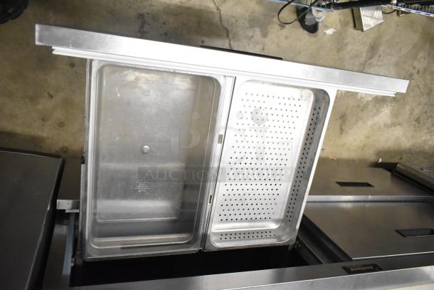 Delfield UCD4464N-12-DD5 stainless steel sandwich prep table with bain marie, overshelf, and 4 drawers on casters.