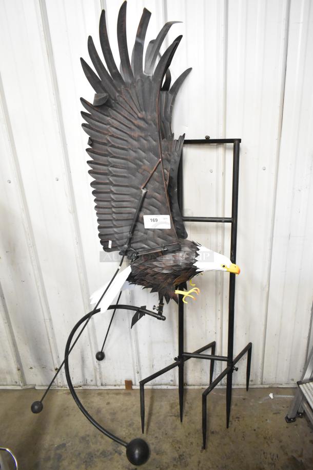 Decorative eagle sculpture with a stand, featuring intricate feather details. Includes a label with "169" on the wing.