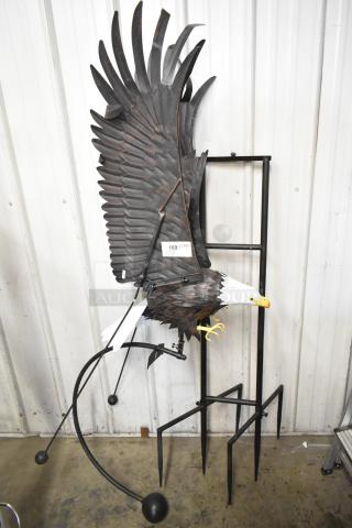 Decorative eagle sculpture with a stand, featuring intricate feather details. Includes a label with "169" on the wing.