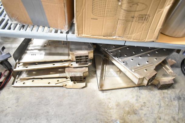 Six metal oven pieces with vented design, stacked on a shelf. Auction tag labeled "171 QTY." Used condition.