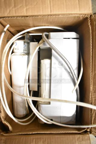 Bawell 2195 Platinum Water Ionizer in used condition, includes hoses and filters, packed in a cardboard box.