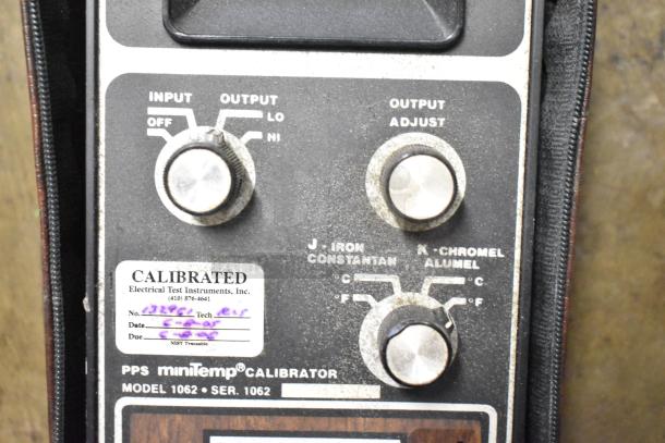 PPS MiniTemp Calibrator Model 1062, showing input/output knobs, calibration label, and serial number details.