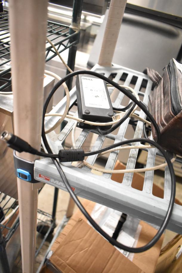 1062 MiniTemp Calibrator with accompanying Dell power supply, used, good condition, visible on a metal shelf.