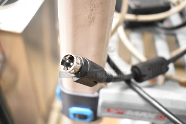 Close-up of a connector plug attached to a cable, part of a 1062 MiniTemp Calibrator set. Appears in operational condition.