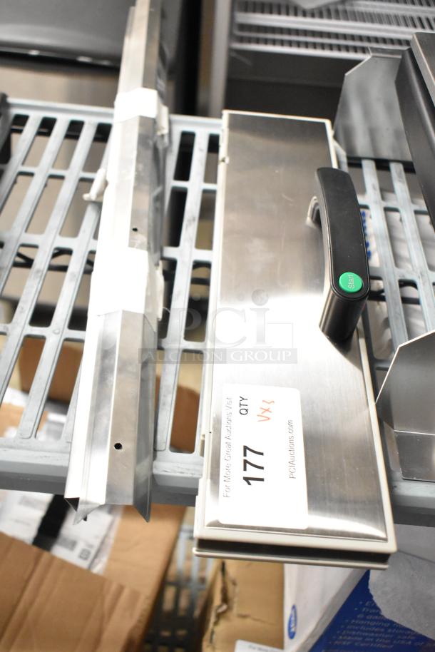 Three auction items: a food processor bowl and two metal pieces. Includes a label marked "177 QTY" on one piece.