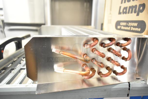 Brand new XCCC 6R4K350L/7.94 evaporator coil with visible copper tubing. Minor scratches, unused condition.