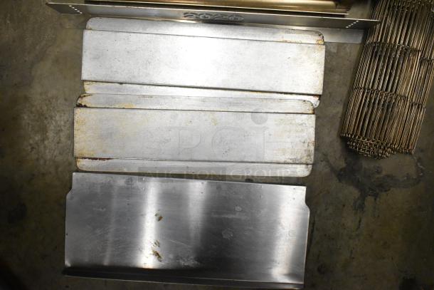9 various metal pieces including a conveyor belt; some aged, others with a polished finish, marked "2020."