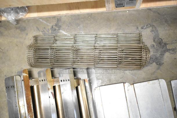 Nine assorted metal pieces including a rusted conveyor belt, various sizes, used condition, industrial auction lot.