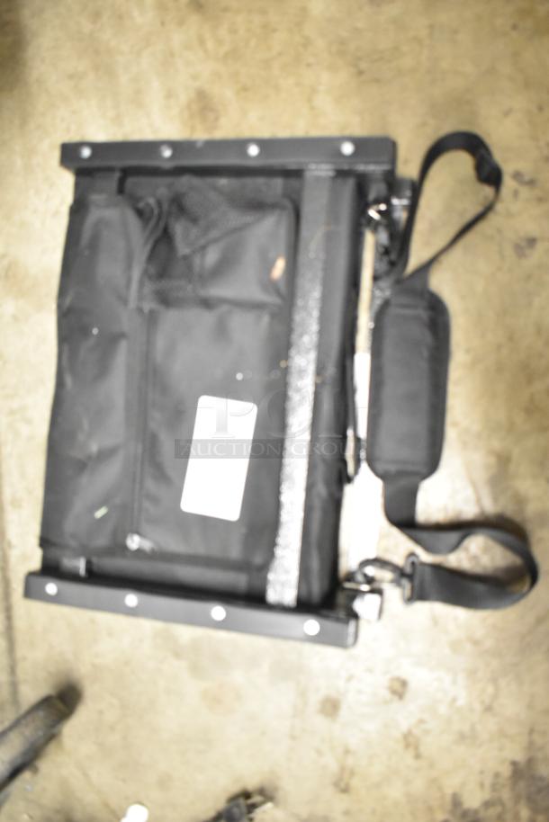 Black Sport Beats Seat Cushion with adjustable strap, mesh pockets, and visible label. Slight wear on fabric. Suitable for stadium use.