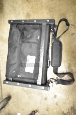 Black Sport Beats Seat Cushion with adjustable strap, mesh pockets, and visible label. Slight wear on fabric. Suitable for stadium use.