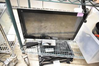 HP All In One Desktop, black, screen with stand detached. Includes power cable. Good condition with visible labels.