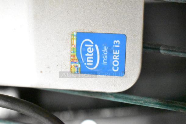 HP All In One desktop with Intel Core i3 sticker. Silver casing, visible wear. Suitable for office or home use.