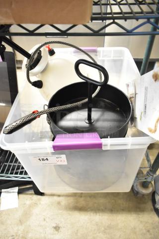 Clear storage bin with a Roundup sprayer, black cupcake stand, and fall-themed sign. Auction tag marked "184, QTY 3X".