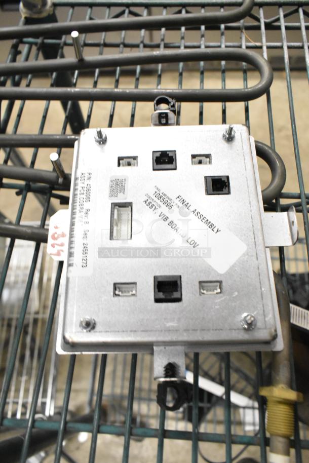 Metal burner with various ports and connectors, labeled "Final Assembly," model T050596. Appears in used condition.