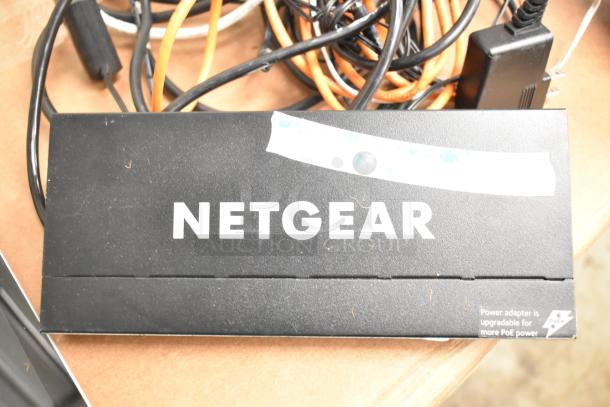 Netgear box with visible label indicating upgradeable PoE power; part of a 5-item auction package including electronics.