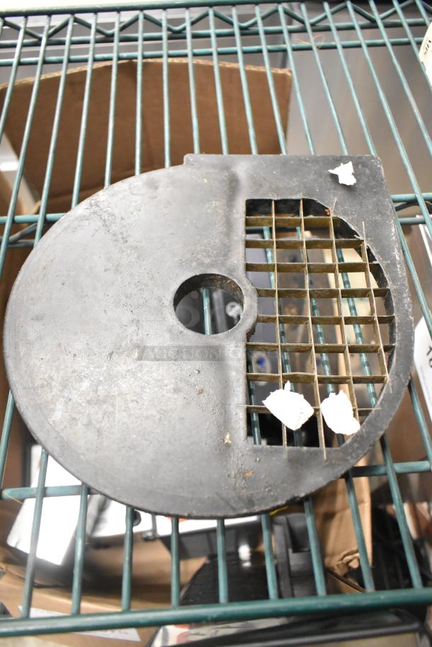 Food processor grate blade, round shape, grid pattern, used condition, visible dirt.