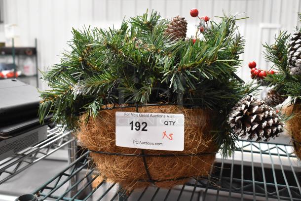 Three artificial pine basket arrangements with pinecones and red berries, labeled "192" for auction identification.