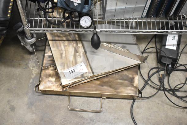 Two metal trays with handles on a wheeled shelf. Auction tag 193 indicates quantity of 2. Good condition.
