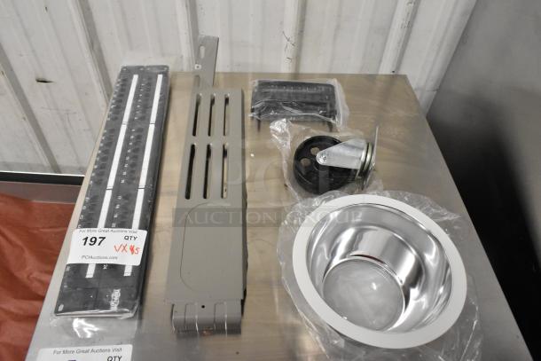 Five assorted items including a caster, metal panels, and a shiny metal bowl. Includes measuring sticks. Labeled for auction.