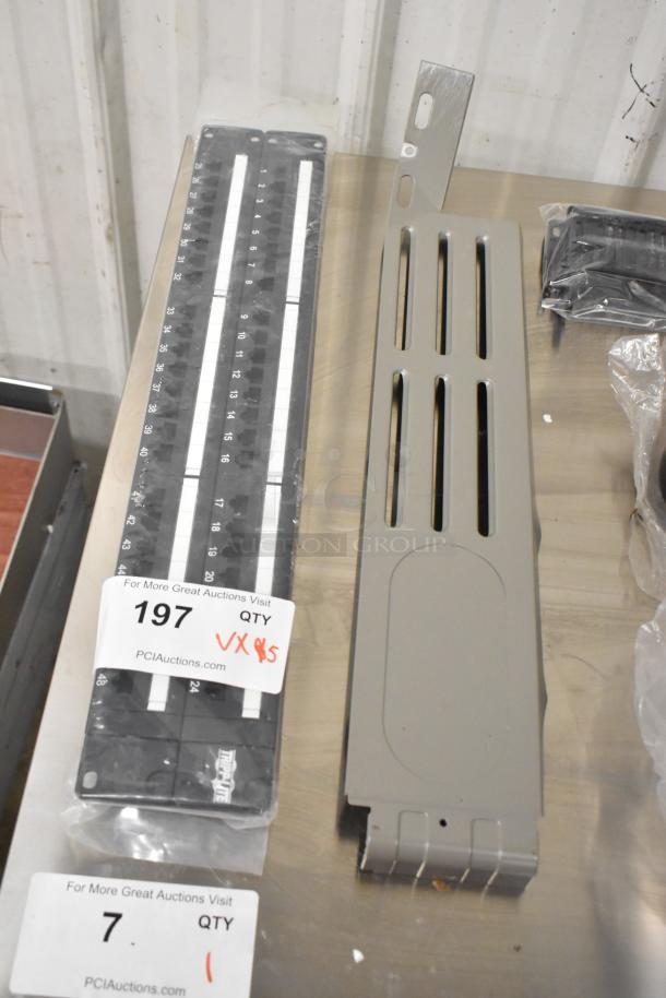 Assorted items including a caster, panels, metal bowl, two numbered labels indicating auction details and quantities.