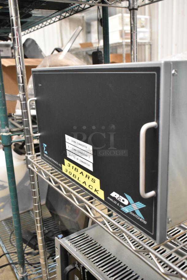 Analog & Digital Switchers A&D Unit on metal shelf. Features handle, down and up converter labels, serial numbers, and brand marking.